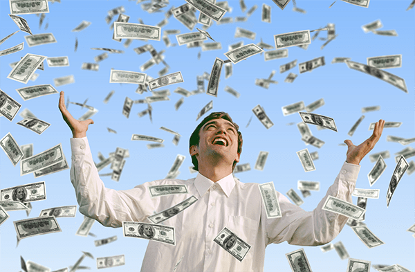Man is happy as thousands of dollars in cash rains down on him as if from Heaven.